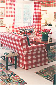 a living room with red and white checkered furniture