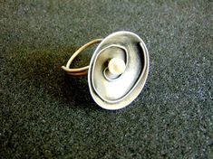 Beautiful women's statement ring. It is made completely out of sterling silver (aka silver 925 each piece is stamped), with a small round pearl in its center...------> If you do not know, or you are not sure about your ring size, the ring will be adjustable<----------->A useful guide to help you determine your ring size: http://www.ringsizes.co/ <------This beautiful ring is brought to you by Filigrane jewelry lab that we have the pleasure of working with! Modern Silver Pearl Ring As Gift, Modern Silver Pearl Ring For Gifting, Modern Sterling Silver Pearl Ring For Gift, Modern Sterling Silver Pearl Ring As Gift, Unique Sterling Silver Pearl Ring In Silver, Unique Sterling Silver Pearl Ring, Unique Silver Pearl Ring, Unique Silver Pearl Promise Ring, Greek Art