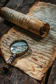 a magnifying glass sitting on top of an old piece of paper with writing