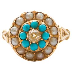 Indulge in the opulent allure of this antique 14 karat gold ring, a masterpiece of elegance and sophistication. Around the center, button-shaped turquoise stones glitter, radiating a captivating hue reminiscent of the azure sea. Surrounding these vibrant blue gemstones are delicate blister pearls, whose natural beauty adds an air of timeless sophistication. At the center of the ensemble is a truly beautiful champagne-colored diamond, sparkling with understated glamor and accentuating a touch of heavenly charm to the composition. Each element of this ring is expertly crafted to perfection, from the intricate detailing of the gold setting to the flawless arrangement of the gemstones. With a total gross weight of 4.9 grams, this 17 mm (US 6.5) ring exudes a sense of substance and luxury, maki Luxury Antique Turquoise Gemstone Ring, Pearl Gold Ring, Color Champagne, Turquoise Stones, Diamonds And Gold, Champagne Diamond, Vibrant Blue, Blue Gemstones, Gold Jewelry Fashion