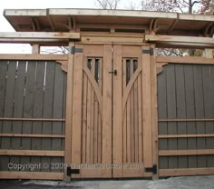 a wooden gate with two doors on each side