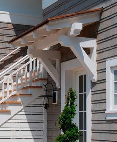 an image of a house with stairs on the front and side porchs above it