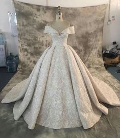 a white wedding dress on display in a room