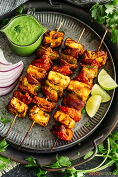 skewers of satay with cilantro, lime and guacamole