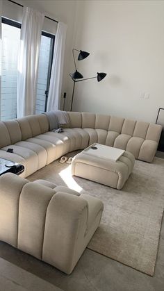 a large sectional couch sitting on top of a white rug