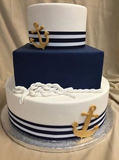 a blue and white cake with an anchor on top