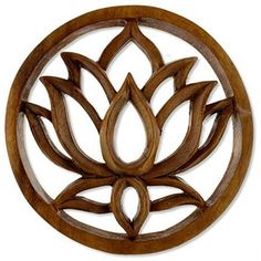 a wooden wall hanging with a flower design on it's center piece in the shape of a circle