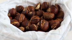 some nuts are in a white bowl on a table