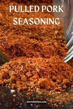 a spoon full of pulled pork seasoning sitting on top of a table with the words pulled pork seasoning over it