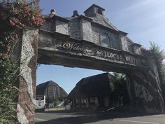 an old stone building with a sign that says welcome to those who are there on it