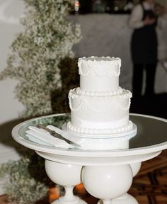 a white wedding cake sitting on top of a table