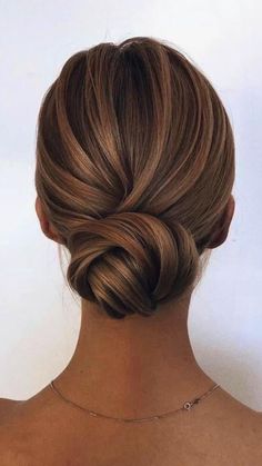 a woman with blonde hair in a low bun