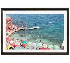 people are swimming in the water at a beach with umbrellas and boats on it