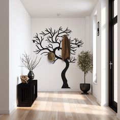 a white room with a tree on the wall and two vases next to it