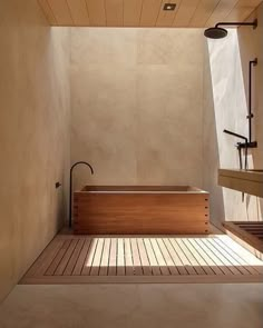 a large wooden bathtub sitting inside of a bathroom