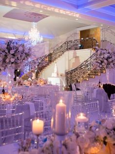 an elegant wedding set up with white flowers and candles