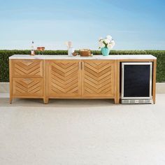 a tv sitting on top of a wooden cabinet