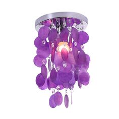 a purple chandelier hanging from the ceiling with crystal beads and flowers on it