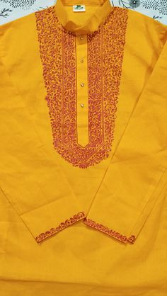 a yellow shirt with red details on the collar