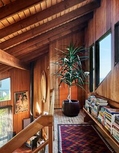 a room with wood paneling and a plant on the floor in front of it