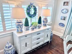 a white table topped with blue and white vases