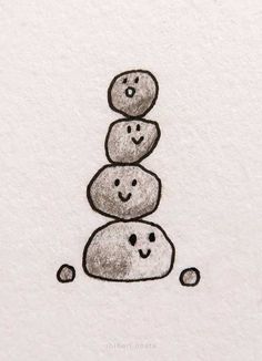 a drawing of three rocks stacked on top of each other with faces drawn on them