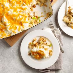 a casserole dish with chicken and vegetables in it on a plate next to the casserole