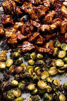 chicken and brussel sprouts on a baking sheet with bbq sauce