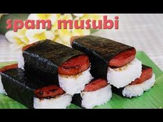 there are four sushi rolls on a green plate with the words spam musubi above it