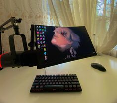 a computer monitor sitting on top of a desk next to a keyboard