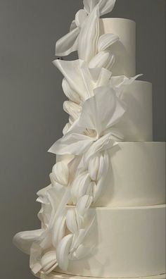 a white wedding cake with flowers on top