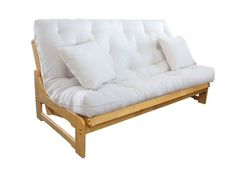 a futon bed with white pillows on it's back and wooden frame in the middle