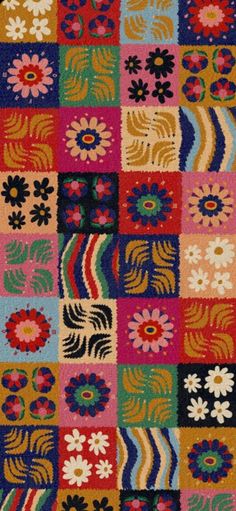 a multicolored patchwork rug with flowers on it