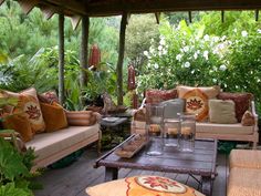 an outdoor living area with couches and tables