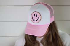 "This hat just screams HAPPY and we are in love. Hat is foam style hat featuring a smiley face patch. Choose your color hat to fit your style. We have several color options to choose from. Hat Details: 100% Polyester foam front, mesh back Structured, five-panel, mid-profile 3 ½\" crown Pre-curved visor with braid detailing Adjustable double snapback closure" Fun Flat Brim Bucket Hat, Fun 5-panel Hat, One Size Fits Most, Cute Snapback Hat With Curved Brim, Fun 5-panel Hat, Fun Snapback Baseball Cap, Fun 5-panel Spring Hat, Fun White Snapback Hat, Fun Snapback Trucker Hat, Fun White 5-panel Hat