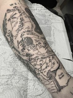 a man's arm with a map tattoo on it