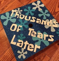 a blue graduation cap that says thousands of years later on the front and sides with snowflakes all over it