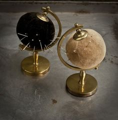 two gold and black globes sitting on top of each other