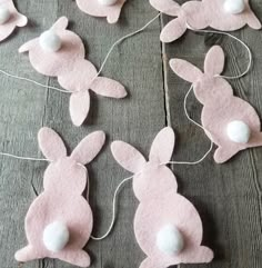 some pink felt bunnies with white balls on them