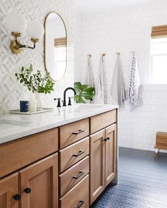 a bathroom with wooden cabinets and white tile