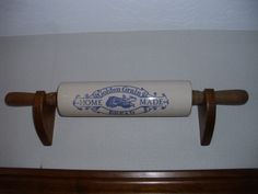 a roll of toilet paper sitting on top of a wooden handle