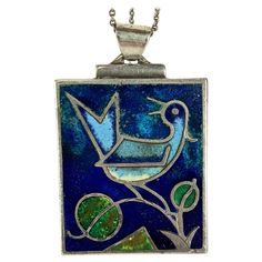 Elegant Modernist Enamel Pendant from Germany circa 1940's. Charming matte enamel bird on branch in cobalt, sky blue and green in a stepped Deco sterling setting with original "T" closure on chain. Green enamel on back. Marked 935 for silver standard. Chain 17", Pendant 1.75" x 1.2". Bird On Branch, Style Deco, Enamel Bracelet, Green Enamel, Blue And Green, Cobalt, Anklets, Sky Blue, Blue Sky