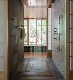 an open door leading to a bathroom with a shower head and hand held faucet