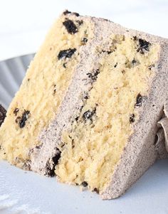 a piece of cake sitting on top of a white plate next to an oreo cookie