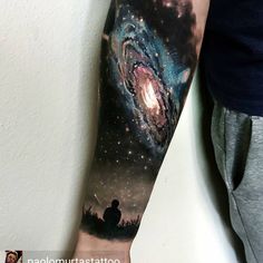 a man's arm with an image of a galaxy on it and the words i love