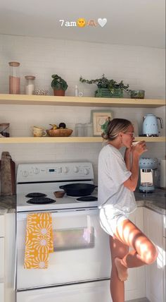 a woman standing on her legs in the kitchen