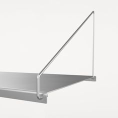 a metal shelf with a triangle on the top and one corner hanging off it's side