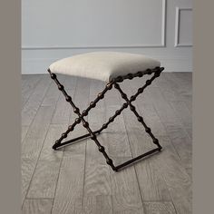 an upholstered foot stool on the floor