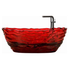 a red glass bowl sink with a black faucet