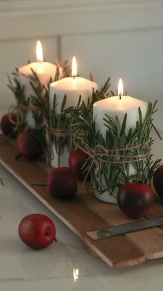 some candles are sitting on a cutting board